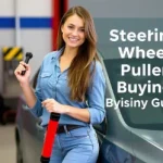 A young woman holding steering wheel puller in auto workshop showing tool for safely removing car steering wheel for vehicle maintenance