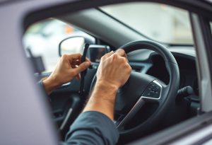 man's hands installing steering wheel lock in modern car showing security lock placement with confidence