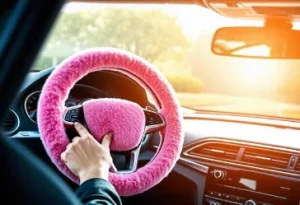 2.	Comfortable pink steering wheel cover in a sleek car interior providing protection and style in a bright sunny environment